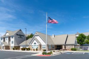an american flag flying in front of a hotel at Residence Inn by Marriott Albuquerque North in Albuquerque