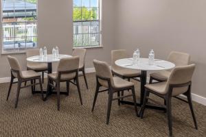 a group of tables and chairs in a room at Residence Inn by Marriott Albuquerque North in Albuquerque