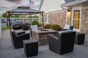 a patio with a table and chairs and a fire pit at Residence Inn by Marriott Albuquerque North in Albuquerque