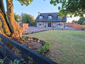 a house with a fence in front of a yard at White Quarry House in Navan