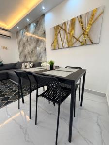 a dining room with a black table and chairs at Luxury NEW Stylish apartment Bayahibe with pool in Bayahibe