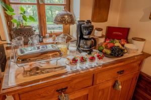 a kitchen counter with a buffet of food and fruit at Apartmány Stodola in Malá Morávka