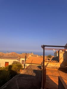 a view of the roofs of houses and the ocean at B&b Al Castello in Gerace +14 photos