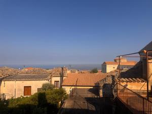 a view of a town with buildings and the ocean at B&b Al Castello in Gerace