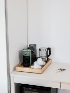 a kitchen counter with a coffee maker on a cutting board at Ritrovare Country House in Citta' Sant'Angelo