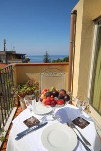 a plate of fruit on a table on a balcony at Hotel Scilla in Scilla