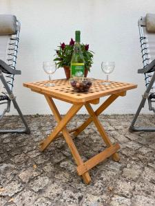 a picnic table with two glasses and a bottle of wine at Quinta dos Lagares in Espadanal +26 photos