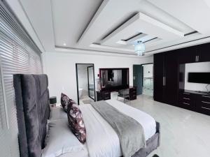 a bedroom with a large bed and a television at Kumnandi Guesthouse in Beacon Bay +54 photos