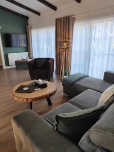 a living room with a couch and a table at La Brise des Fagnes in Jalhay