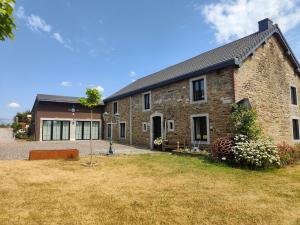a brick house with a yard in front of it at La Brise des Fagnes in Jalhay