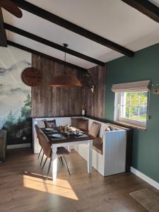 a living room with a table and a couch at La Brise des Fagnes in Jalhay