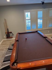 a pool table in a living room with a pool ball at 907 elm in Rodeo