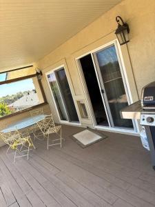a patio with two chairs and a table and windows at 907 elm in Rodeo