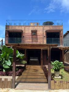 a large wooden house with a wooden walkway at Vista do Pico in Fernando de Noronha