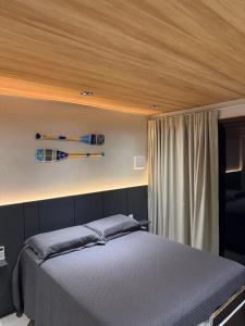 a bedroom with a bed with a wooden ceiling at Vista do Pico in Fernando de Noronha
