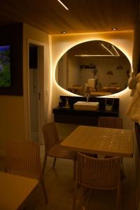a kitchen with a table and chairs and a sink at Vista do Pico in Fernando de Noronha +17 photos