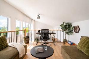 a living room with a couch and a table at Modern Comfort - Spa - Mountain - Chalet KNOX in Saint Come