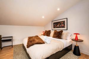 a bedroom with a large white bed with brown blankets at Modern Comfort - Spa - Mountain - Chalet KNOX in Saint Come