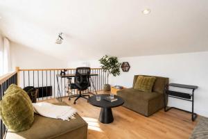 a living room with a couch and a table at Modern Comfort - Spa - Mountain - Chalet KNOX in Saint Come