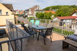 a patio with a table and chairs on a balcony at Ada Niechorze in Niechorze