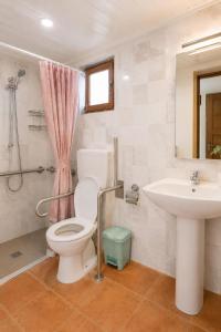 a bathroom with a toilet and a sink at Mandinga Guest house in São Tomé +29 photos