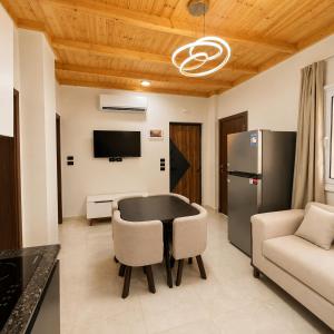 a kitchen and living room with a table and a refrigerator at Sunrise View K8 Apartments in Hurghada