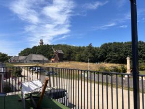 a balcony with a black fence and a windmill at BLOMMA Niechorze in Niechorze