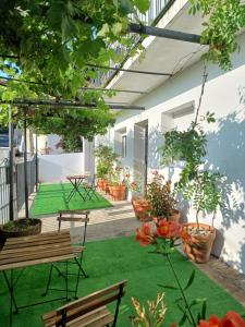 a courtyard with benches and potted plants on a building at Apartamentos Mar de Nanín in Sanxenxo