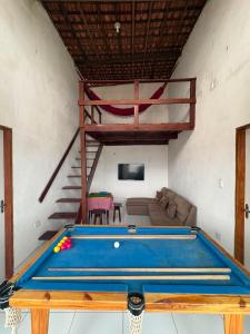 a living room with a pool table and a loft at Casa de Temporada em Bezerros in Bezerros