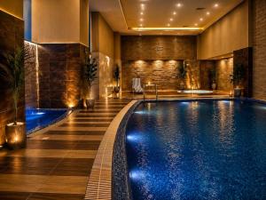 a pool in a hotel room with a swimming pool at The Premier Centauras in Islamabad