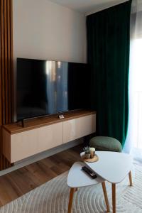 a living room with a large flat screen tv at Salt Square Residence in Tuzla