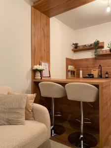 a room with a bar with two chairs and a table at Salt Square Residence in Tuzla