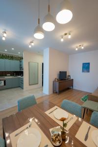 a dining room and living room with a table and chairs at 3-Room Seaview Apartment at Bamboo Beach in Ts'ikhisdziri