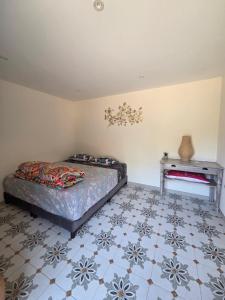 a bedroom with a bed and a side table at Le ranch de Chant'alouette in Étauliers