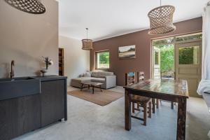 a living room with a table and a couch at Domek pod Grabami in Gdańsk