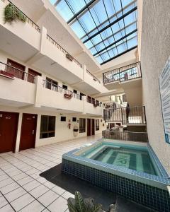 an indoor swimming pool in a building with a skylight at Hotel NV in Guadalajara