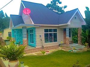 a small house with a pink frisbee on the roof at Usambara Homes in Manga