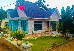 a small house with a blue roof at Usambara Homes in Manga