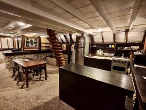 a large kitchen with a wooden table and a dining room at Vahaui Paradis in Avatoru