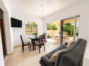 a living room with a couch and a table and chairs at Ocean view in Pointe aux Biches