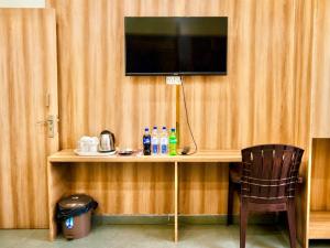 a room with a desk with a television on a wall at New sheth bnb golden temple in Amritsar