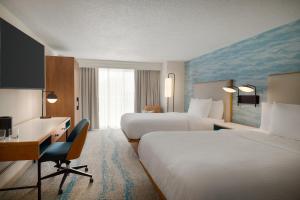 a hotel room with two beds and a desk at Courtyard by Marriott Ocean City Oceanfront in Ocean City +56 photos