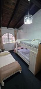 a bedroom with two bunk beds and a chandelier at Lodi House in Godoy Cruz +48 photos