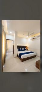 a bedroom with a bed with blue pillows on it at New sheth bnb golden temple in Amritsar +6 photos