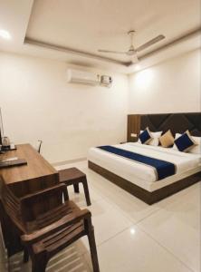 a bedroom with a bed and a desk and a bed sidx sidx sidx at New sheth bnb golden temple in Amritsar