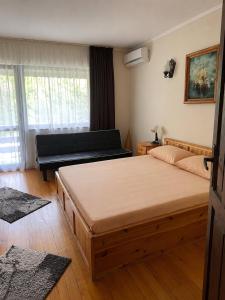 a bedroom with two beds and a piano at Сонита in Yamna +11 photos