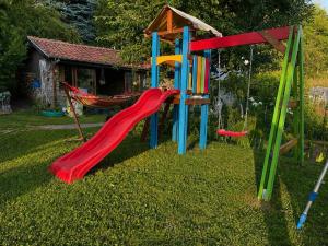 a playground with a slide and a hammock at Сонита in Yamna