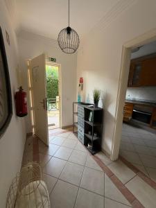 a room with a door open to a kitchen at Moradia Almorávia in Olhos de Água