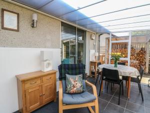 a room with a table and chairs and a dining room at Steam Cottage in Aviemore