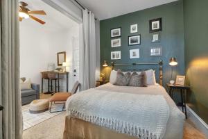 a bedroom with a bed and a green wall at Downtown Palace Hotel Suite - Steps to Adventure in Salida